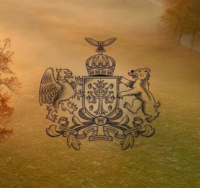 Bespoke family crest design with tree in a shield surrounded by an eagle, bear and crown on an autumn background