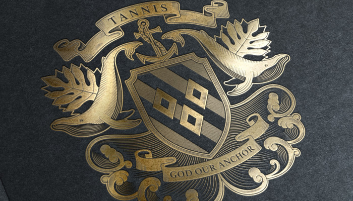 Tannis family crest shield whale design by Root Studio