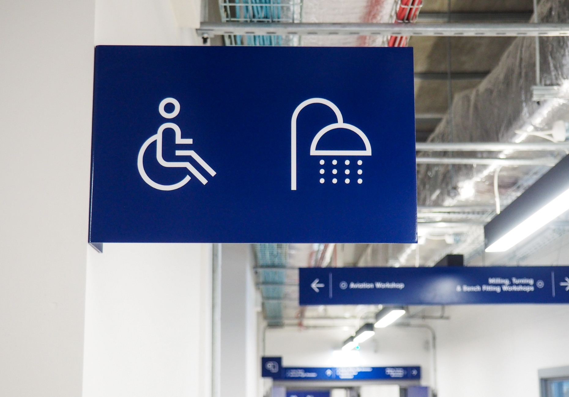 ASI college wayfinding overhead toilet shower icon sign design