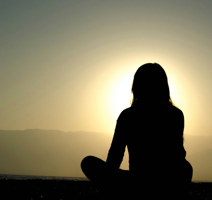 a woman sitting in a peaceful setting