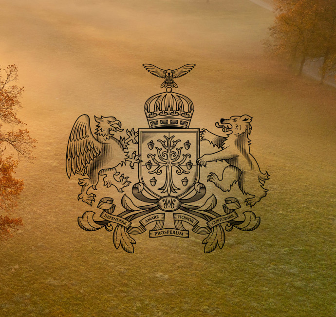 Bespoke family crest design with tree in a shield surrounded by an eagle, bear and crown on an autumn background