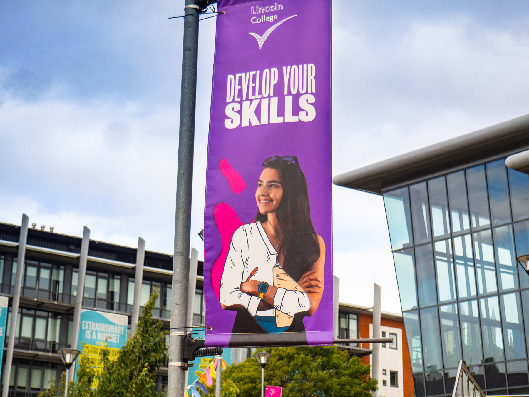Lamp post flag banner design lincoln college education by root studio