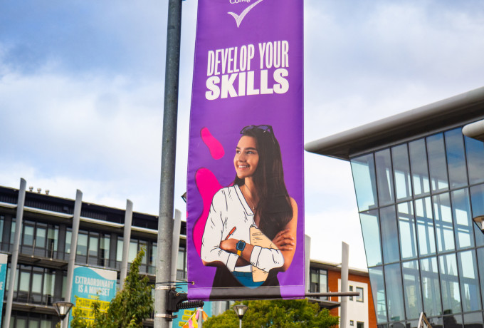 Lamp post flag banner design lincoln college education by root studio