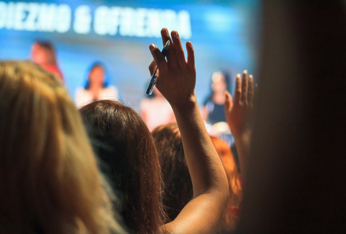Member at a conference raising their hand