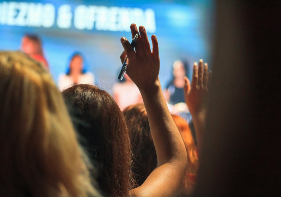 Member at a conference raising their hand